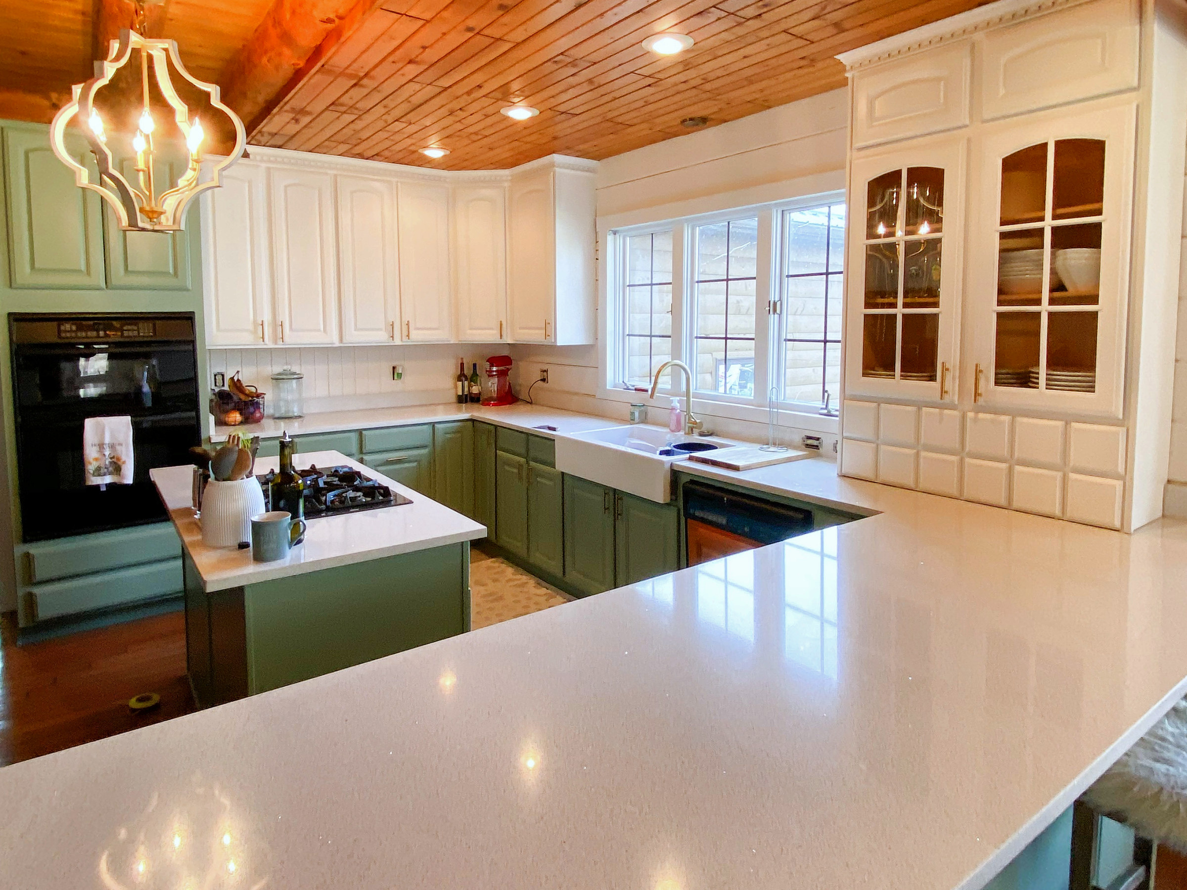 Glass-front cabinets above a long kitchen counter