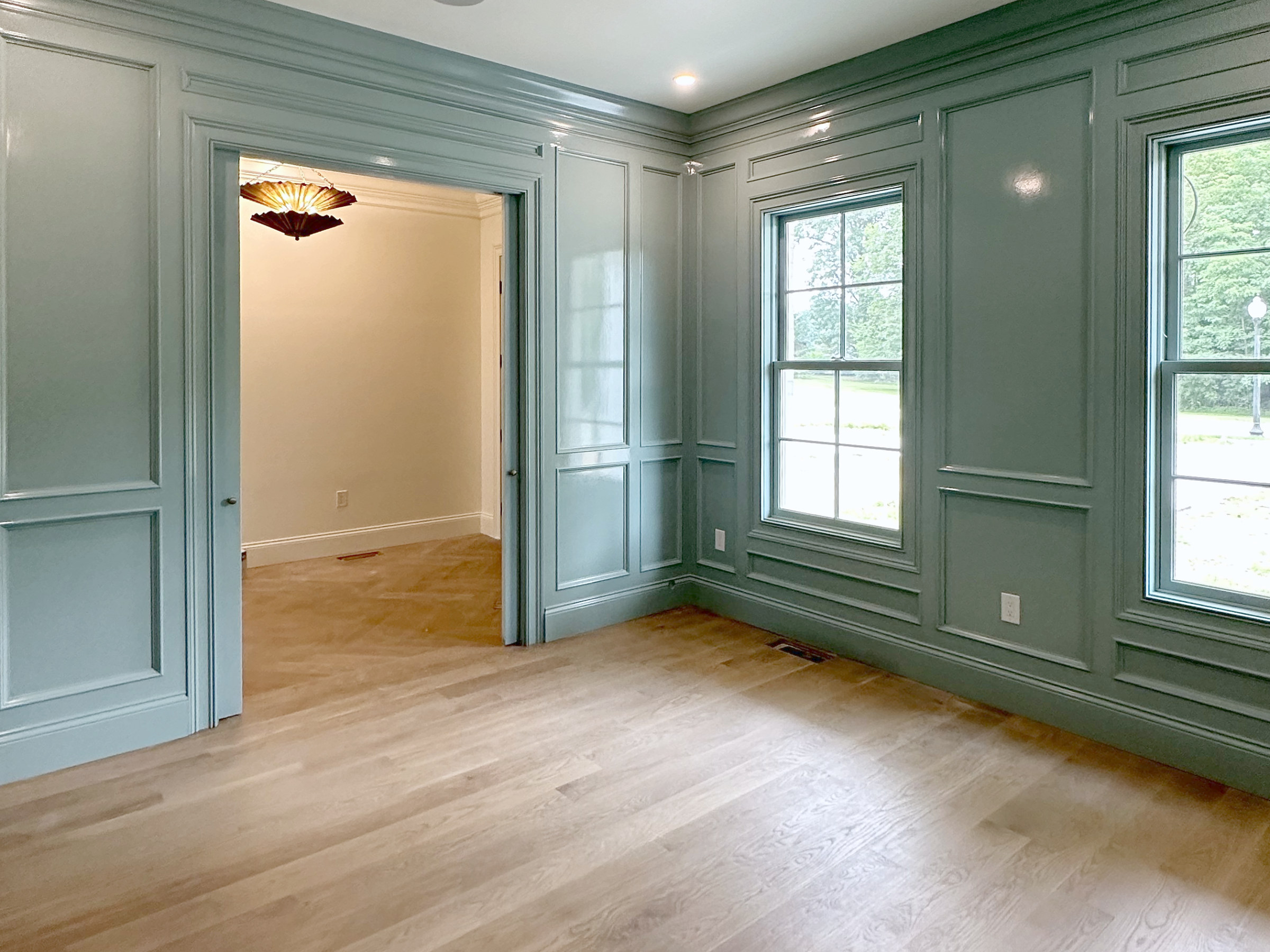 Green paneled walls and window trim