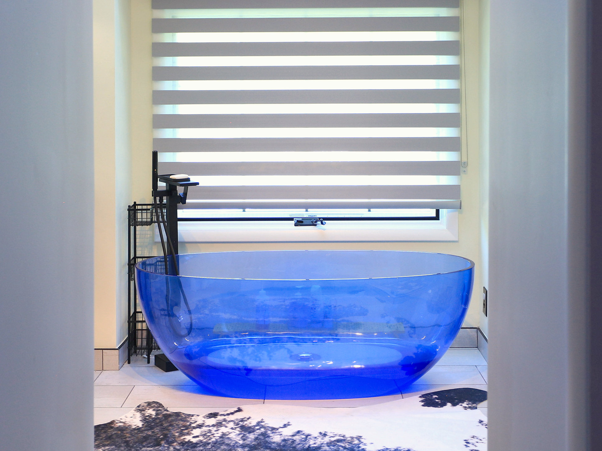 Primary bath with a blue freestanding tub