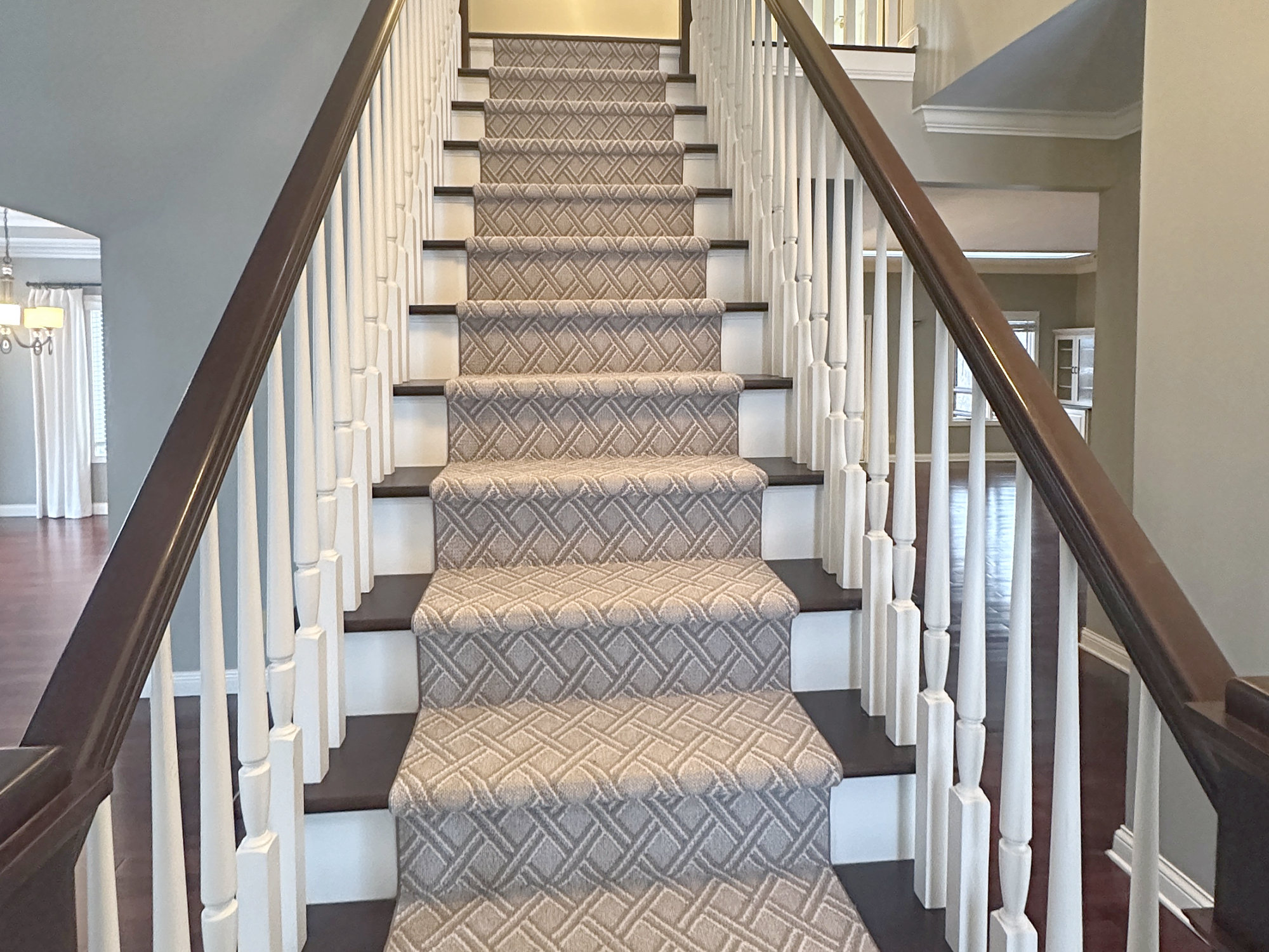 Staircase with white balusters and dark wood railings