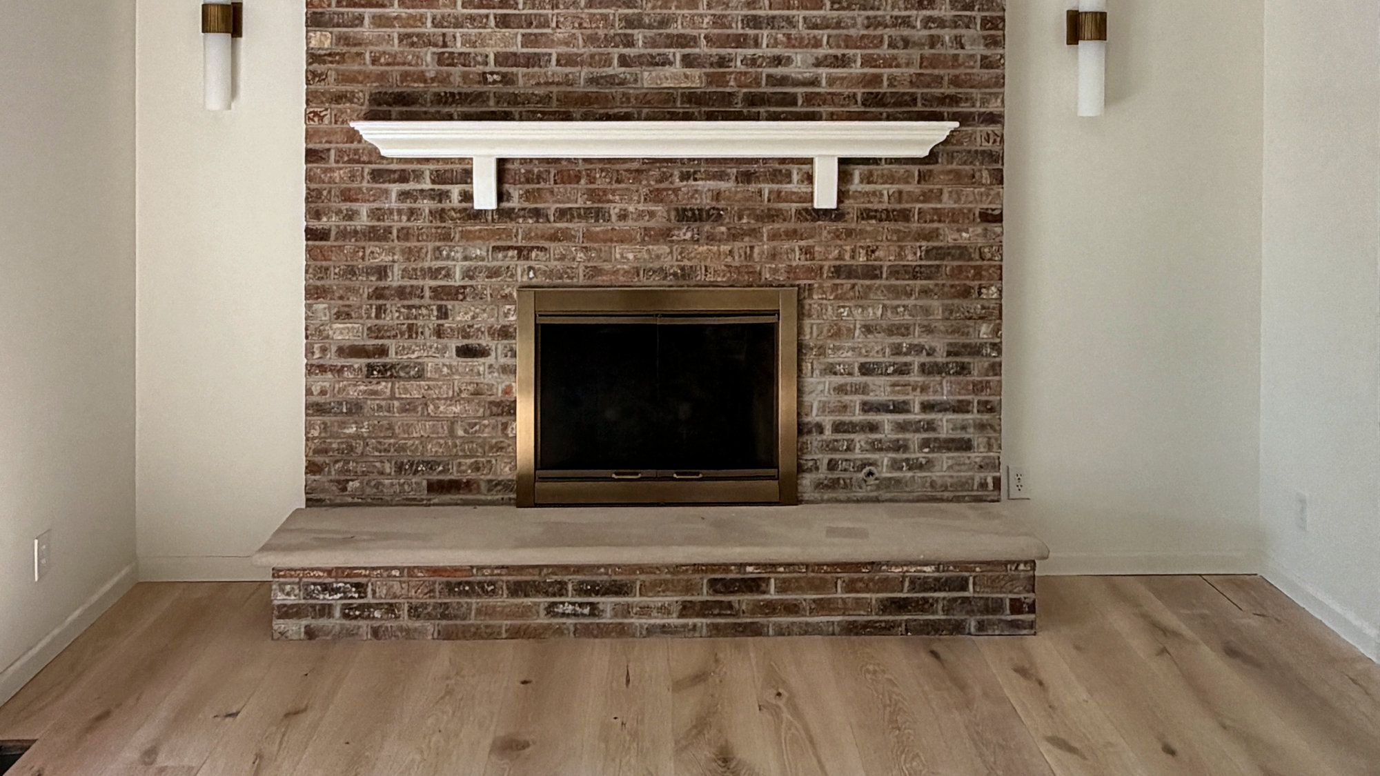 Vaulted living room with a tall brick fireplace