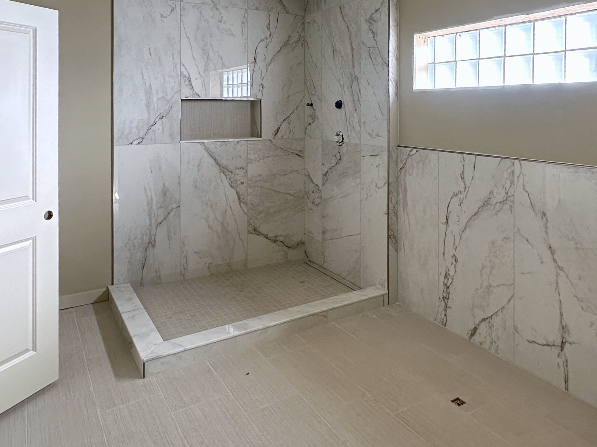 Walk-in shower remodel with large-format tile, in progress
